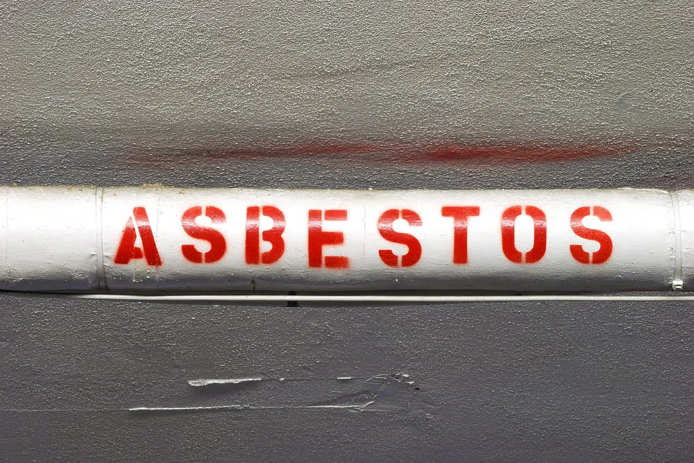 Asbestos pipe insulation on an older pipe for removal and remediation
