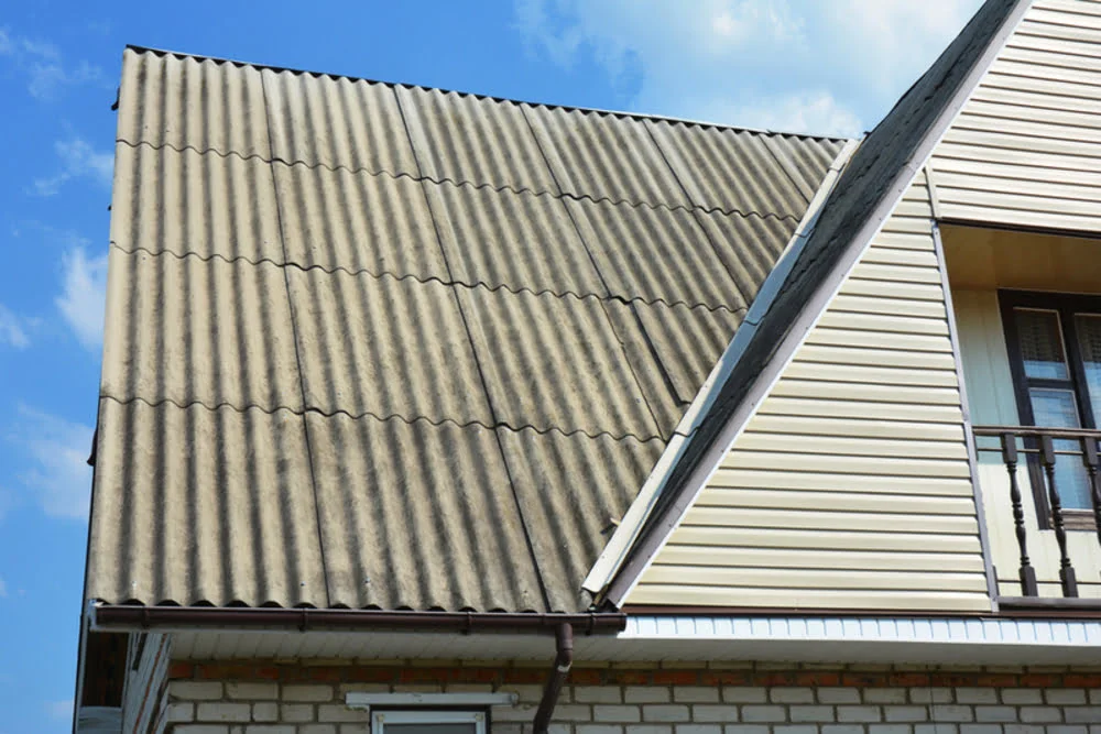 Older home with asbestos roofing during an asbestos real estate inspection