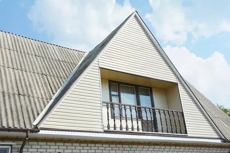 Asbestos siding on the exterior of a house ready for professional asbestos removal