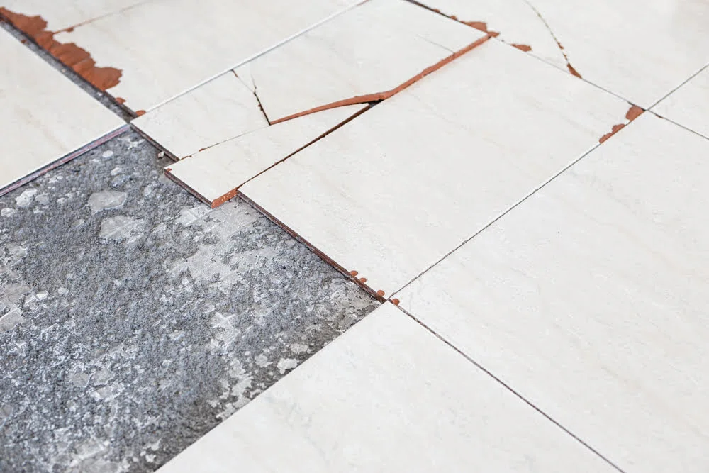Close-up of 9x9 asbestos floor tiles showing potential asbestos contamination