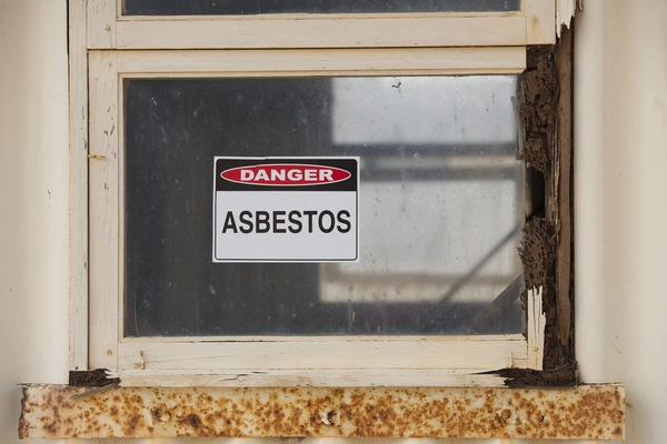 Asbestos danger sign related to vermiculite insulation exposure